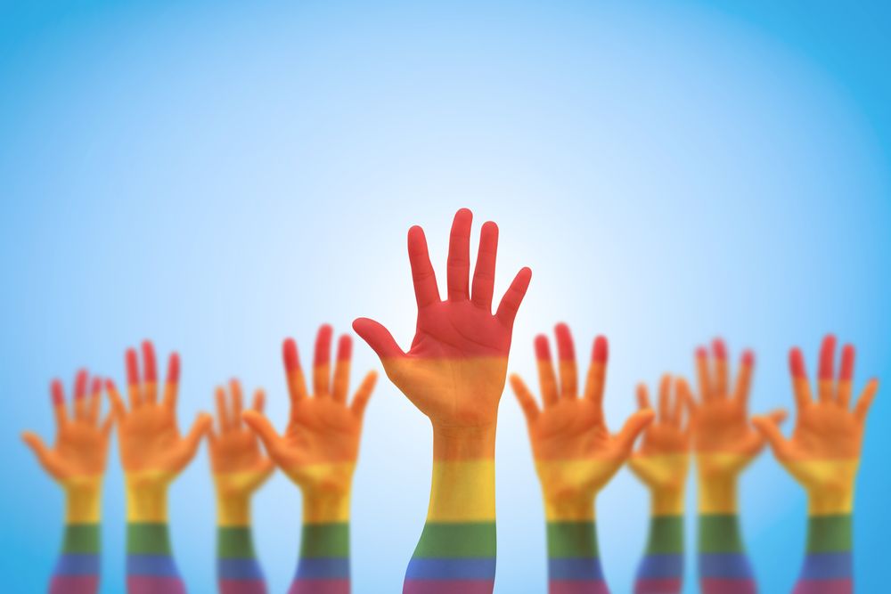 raising rainbow-colored hands